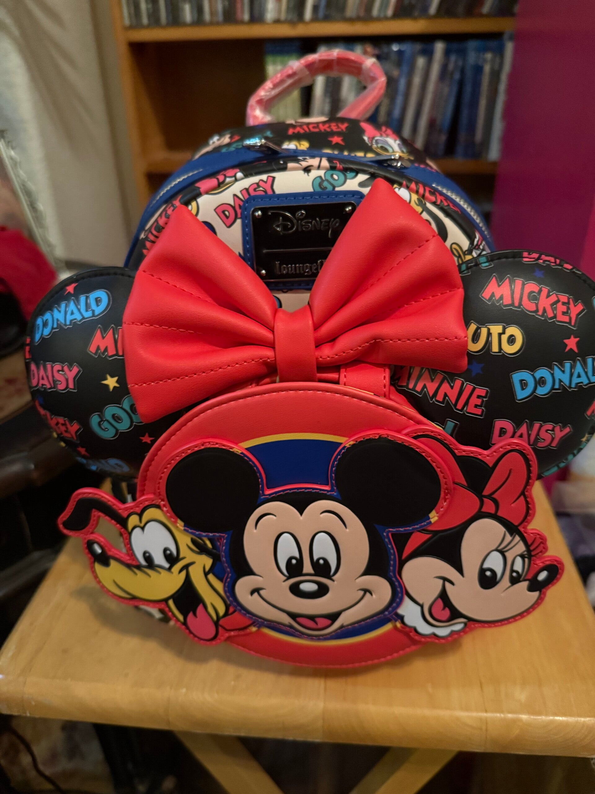 This is a Loungefly Disney Mickey and Friends Classic Stars Mini Backpack with Ears Headband.