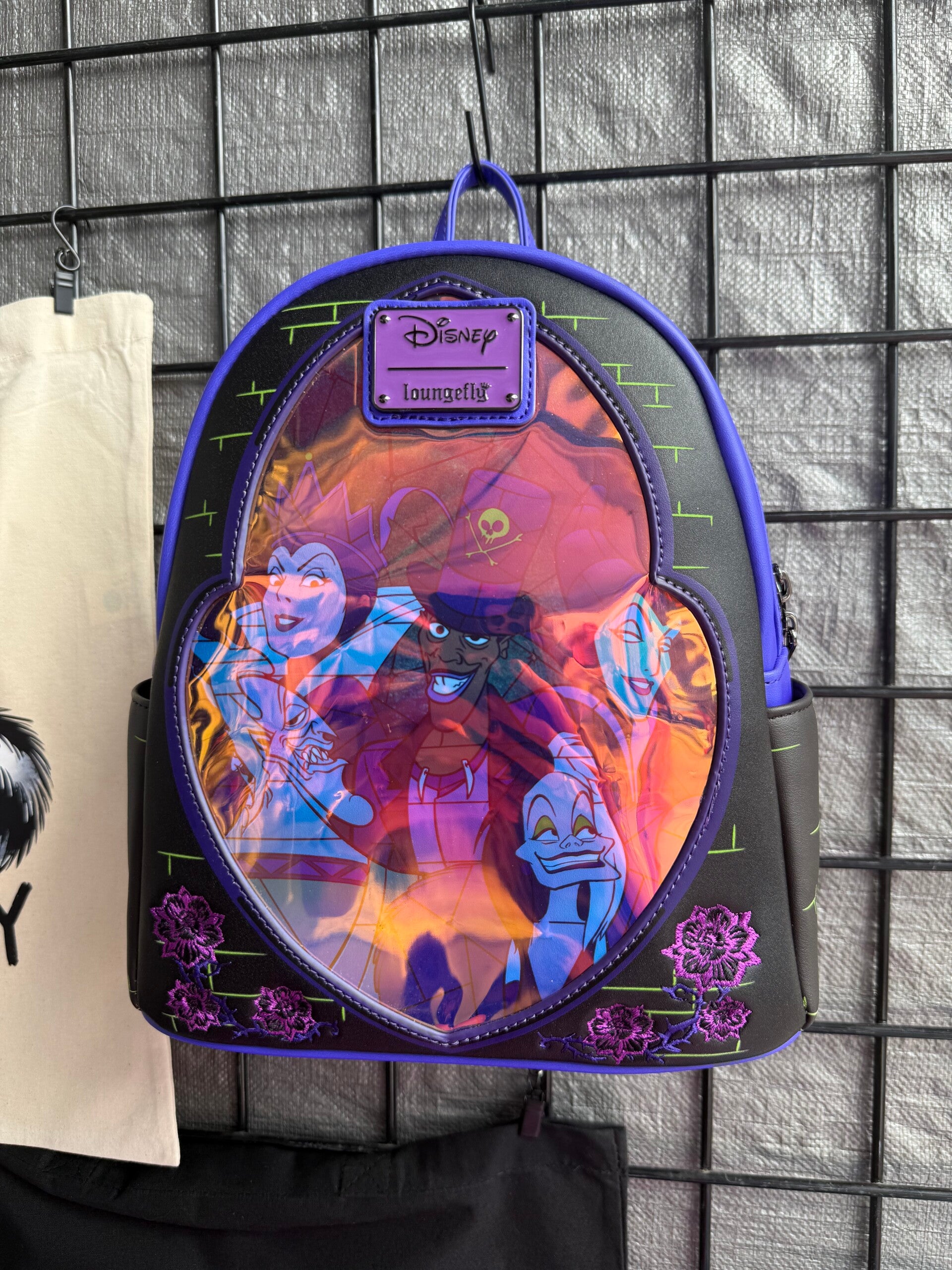 This Loungefly Disney Villains Stained Glass Glow Mini Backpack
