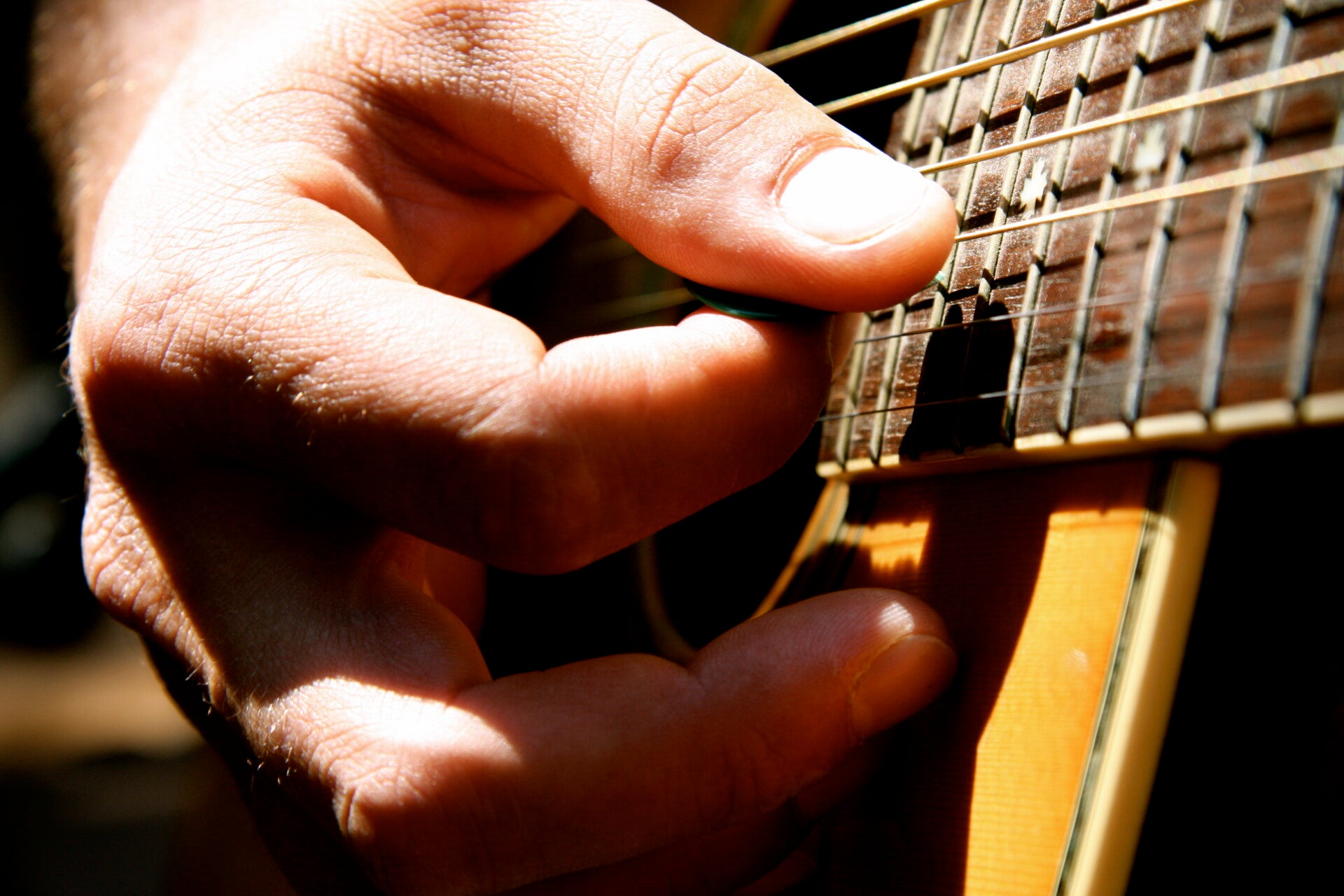 Derek Samuel Reese playing his acoustic guitar in Brooklyn Heights