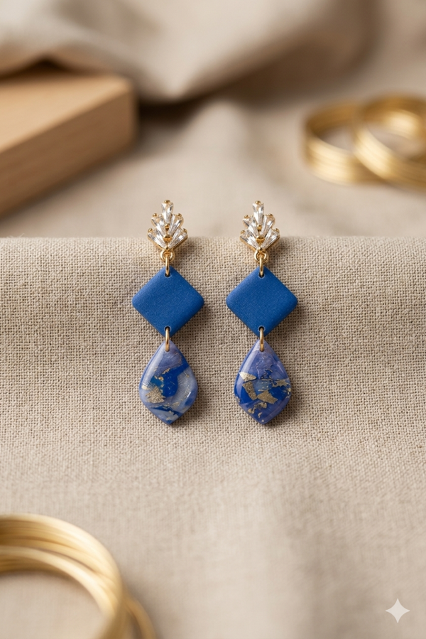 Statement oorbellen blauw goud