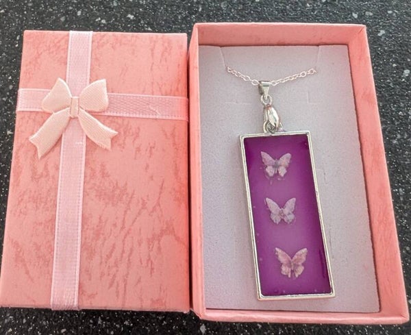 Oblong resin pendant with Butterfly charms