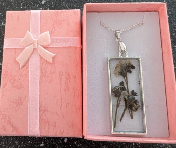 Oblong resin penant finished with Dried Flowers