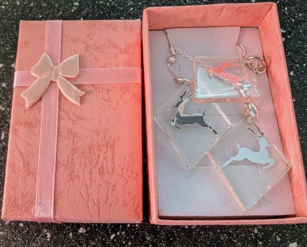 Diamond shped resin pendant and earring set finished with a silver Reindeer