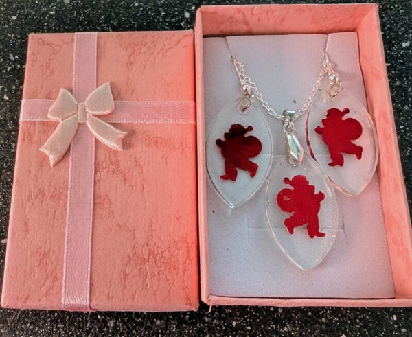 Teardrop resin pendant and earring set finished with a Bold red Santa