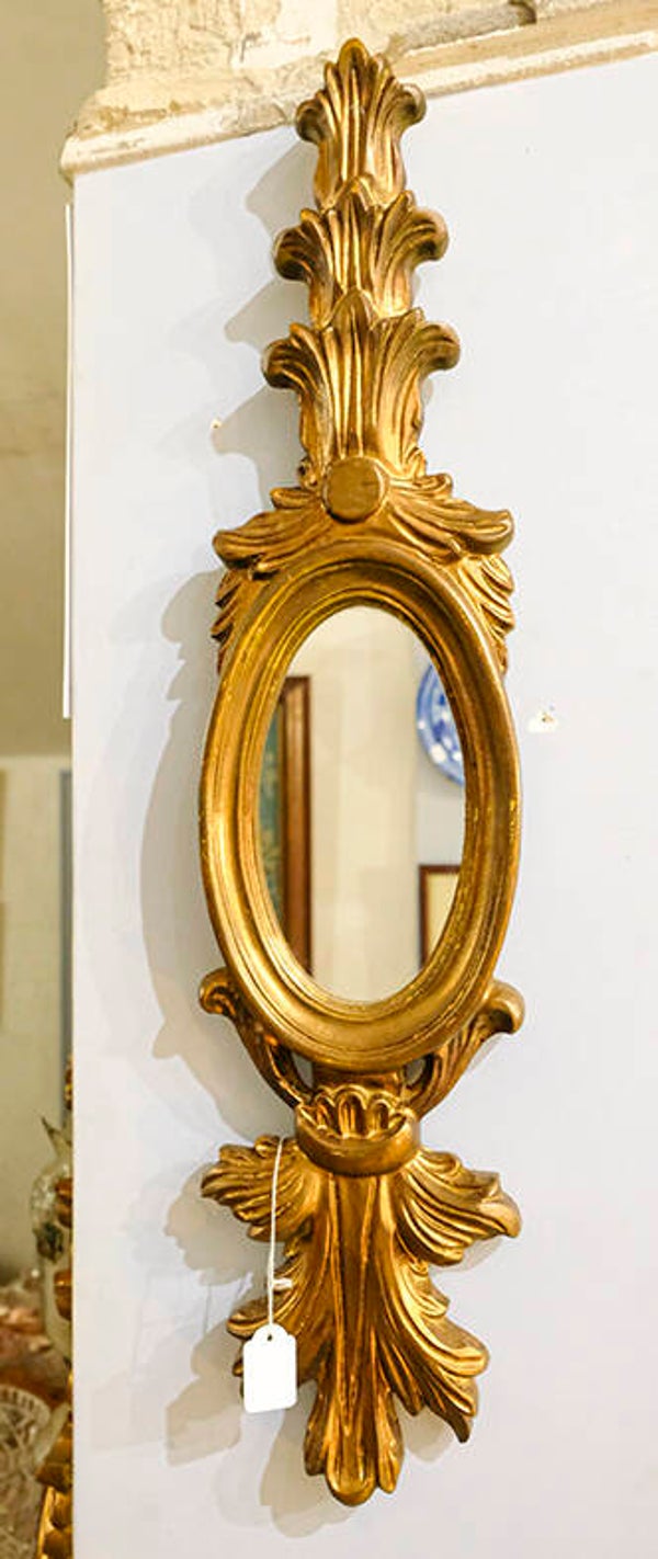 Espejo decorativo dorado ovalado