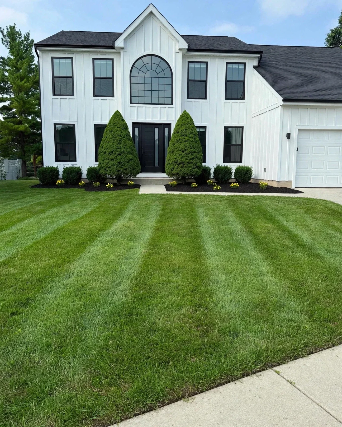 Precision turf mowing with crisp, uniform lawn striping lines for a home in Mason, Ohio.