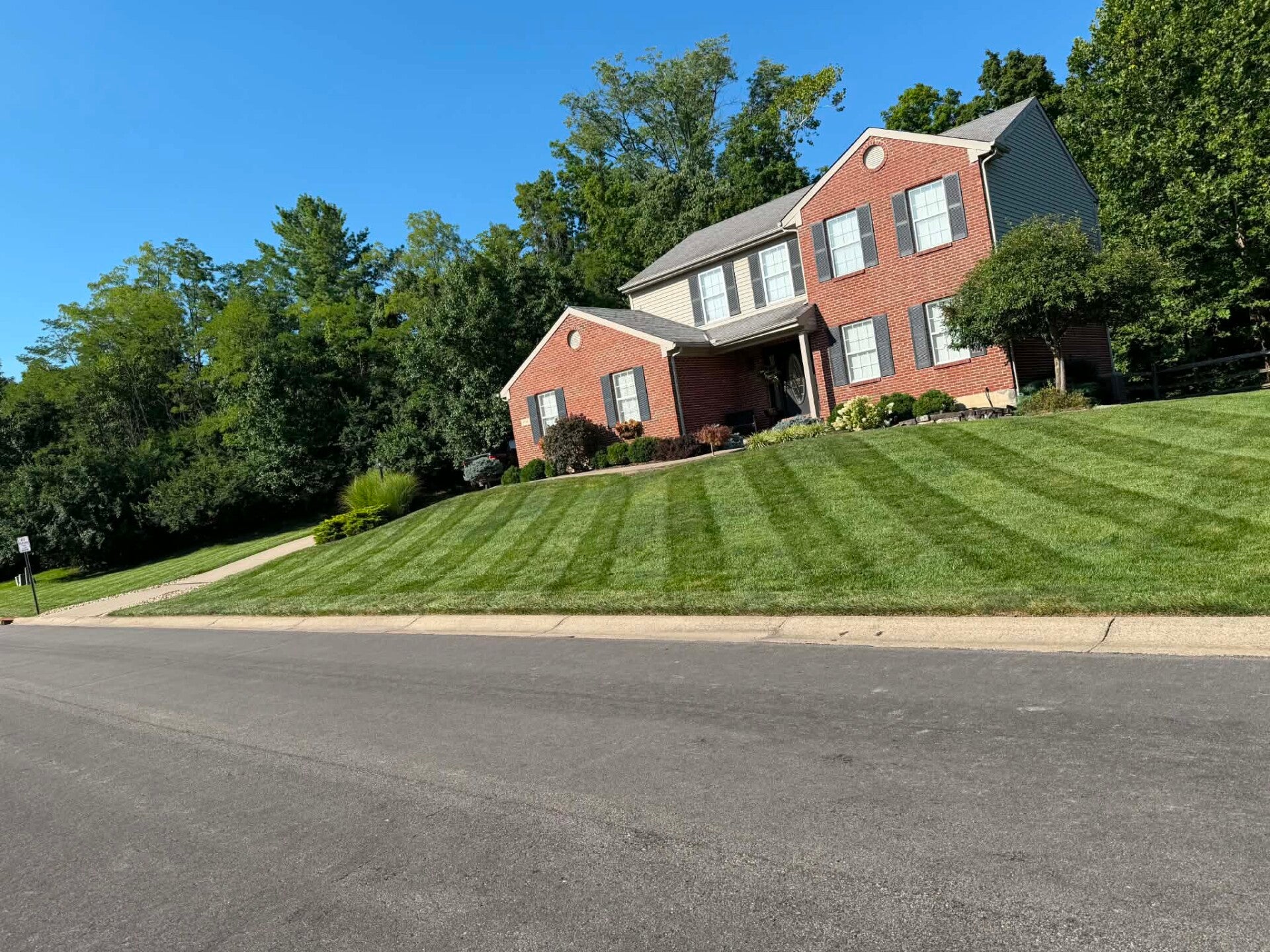 Pristine weekly lawn mowing and driveway edging service completed in Sharonville, Ohio.