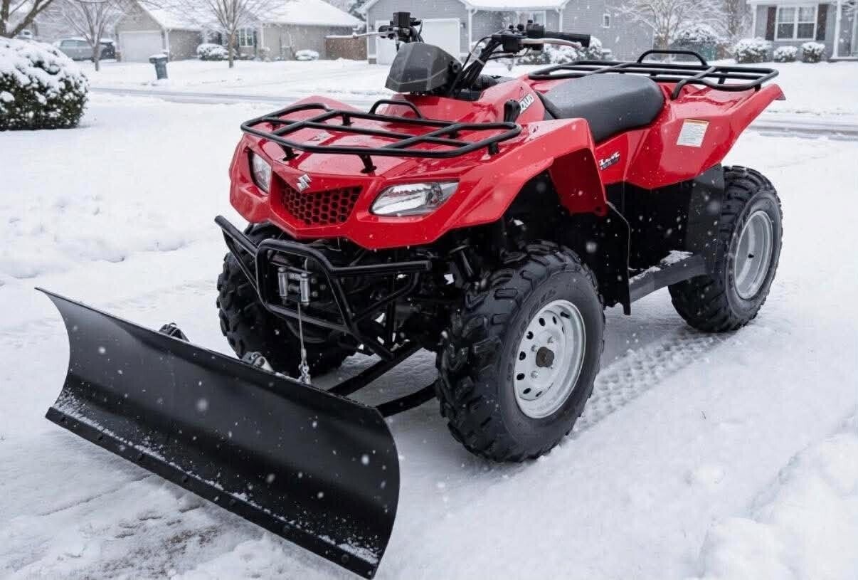 Quad ATV equipped with snow plow clearing snow from residential walkways and parking areas in Cincinnati, Ohio