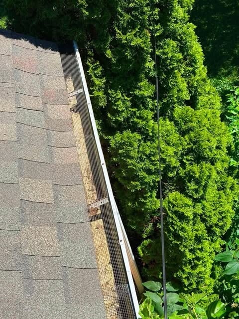 Professional gutter debris removal and roof drainage maintenance in Mason, Ohio.