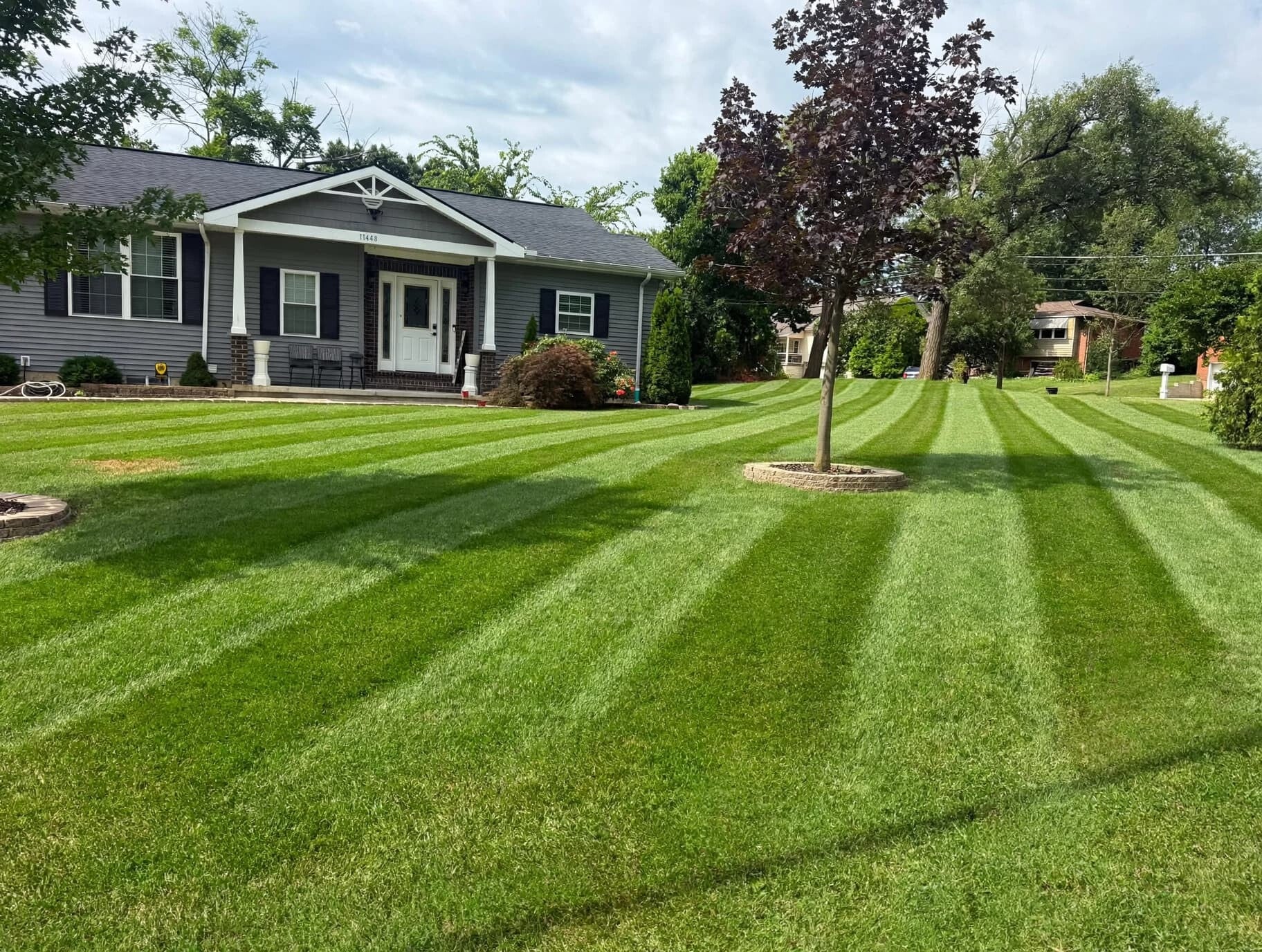 Professionally striped lawn with precision mowing by Nienaber And Sons Lawn Care L.L.C., family-owned lawn care and landscaping services in North Bend and Cincinnati, Ohio