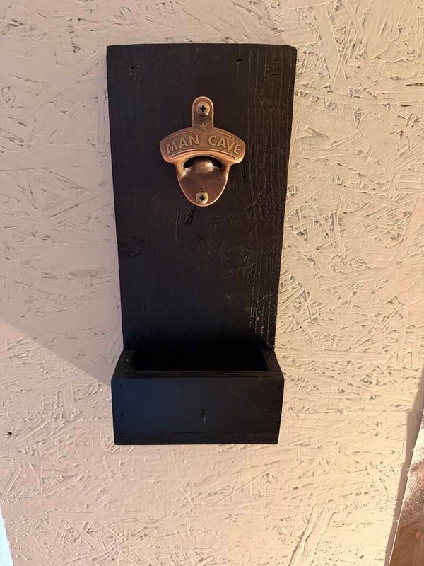 Wall mounted bottle opener with cap catcher