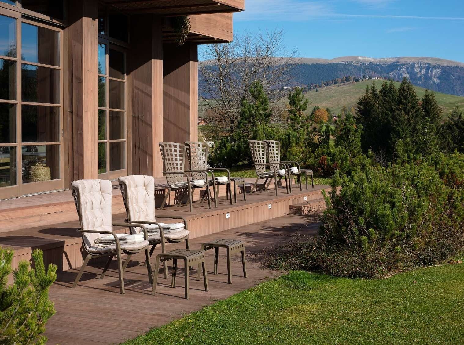 Fauteuils d'extérieur Nardi Folio avec coussins sur une terrasse en bord de jardin
