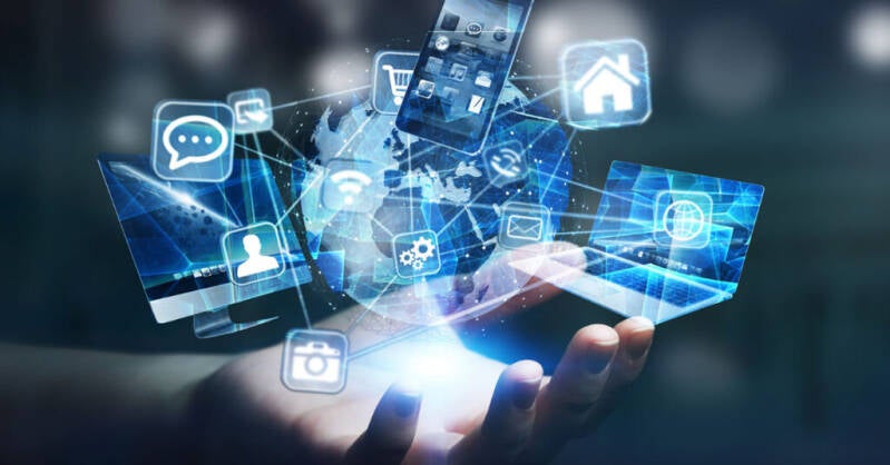 Hand holding a collage of technology images and icons