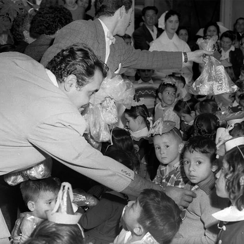 Gaspar Henaine regalando dulces a los niños en los 50's