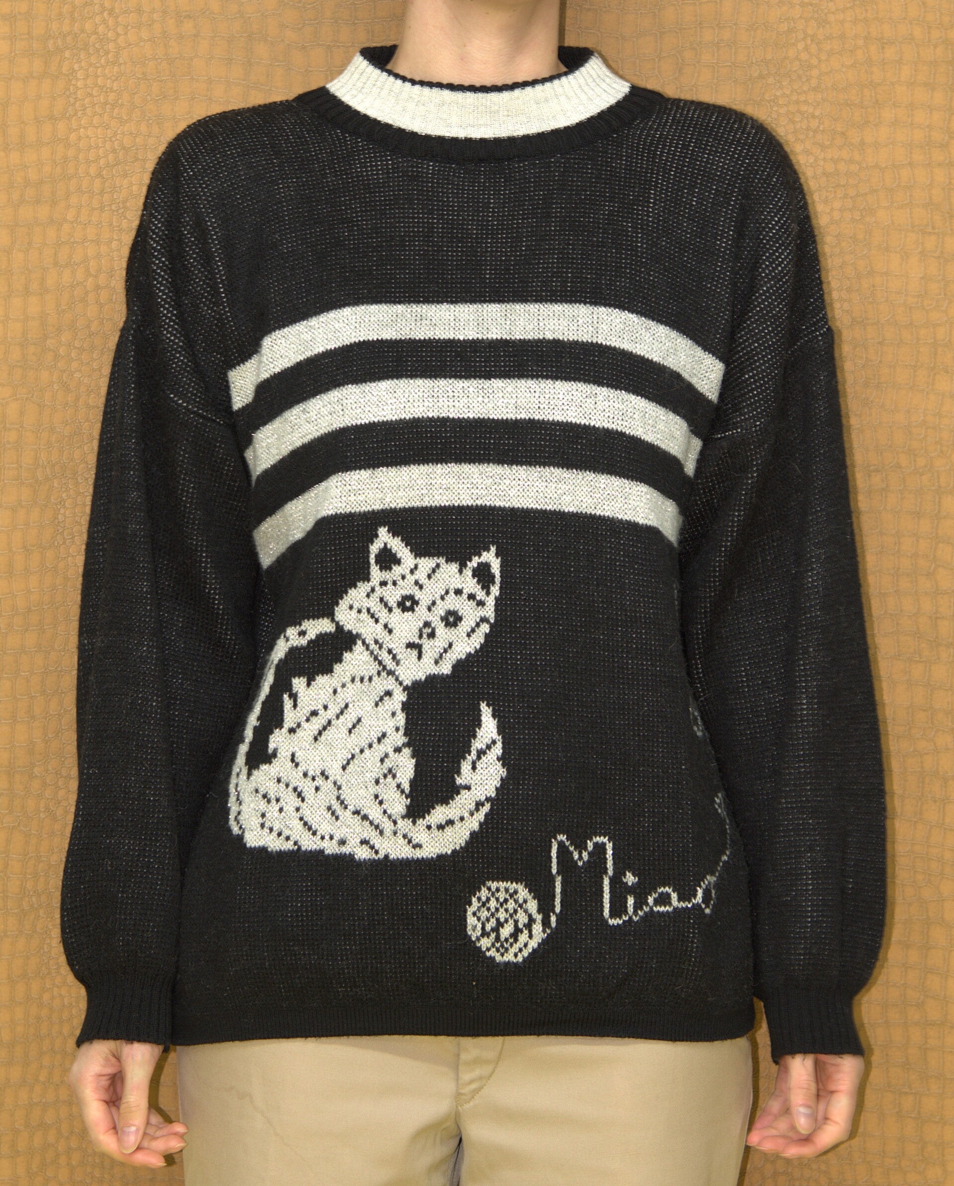 Zwart/zilveren trui met licht verfomfaaide kat