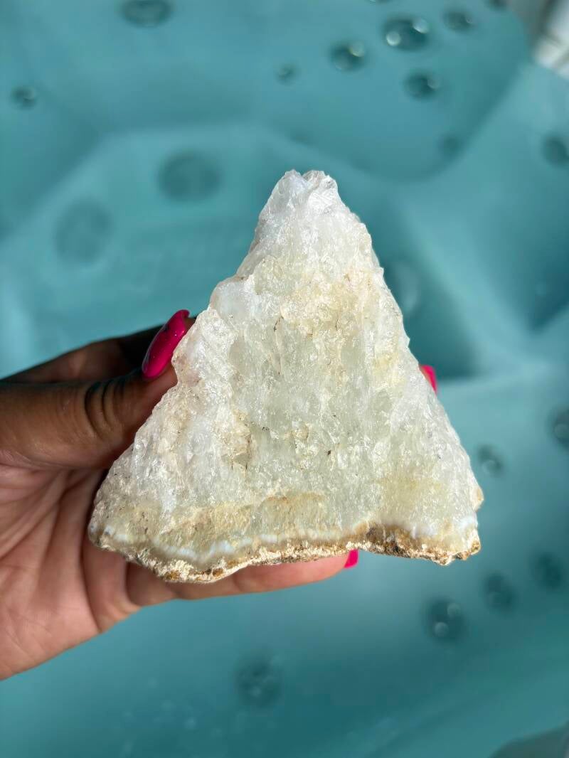 Macro close-up of a raw quartz crystal specimen highlighting thousands of tiny natural points and sparkling internal prism reflections.
