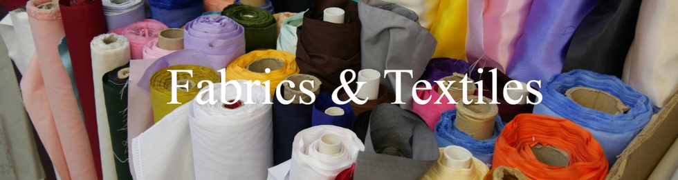 A spectrum of fabric bolts featuring rich colors and intricate designs, perfect for creative projects.