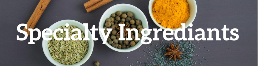 A vibrant assortment of spices displayed in bowls, showcasing a variety of colors and textures.