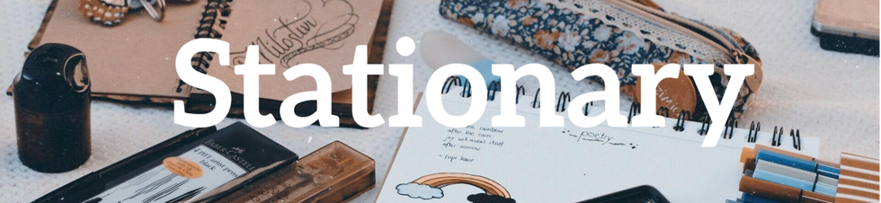 A cozy desk scene with pens, a notebook, a pencil case, a journal, and a pencil sharpener, inviting inspiration