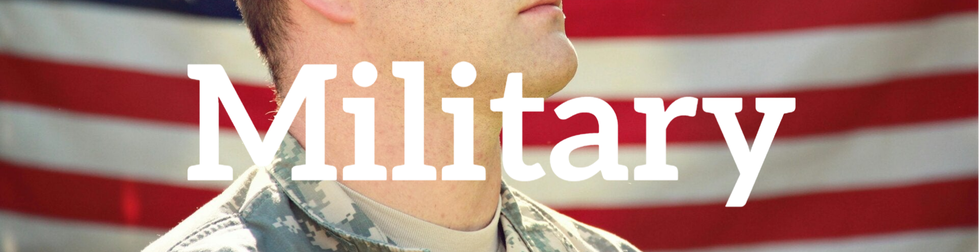 A soldier standing beside a waving military flag with the word 'MILITARY' boldly displayed across it, symbolizing strength and service.