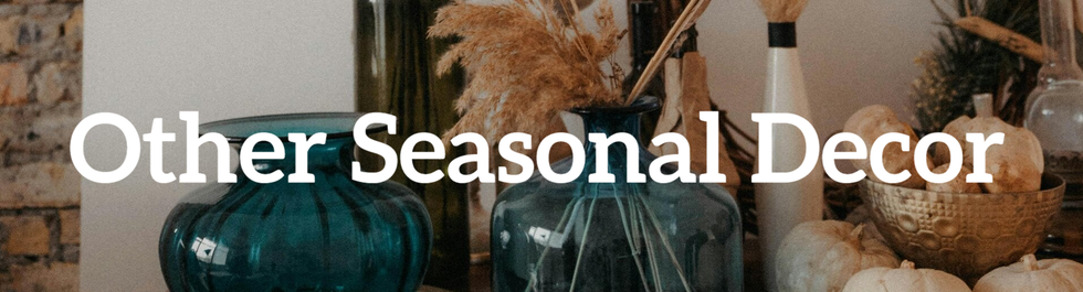 A warm and inviting scene with glass vases, ceramic pumpkins, and faux plants, perfect for seasonal décor