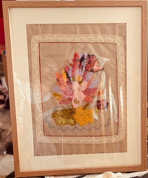 RUPA’S Hand embroidery in a frame.