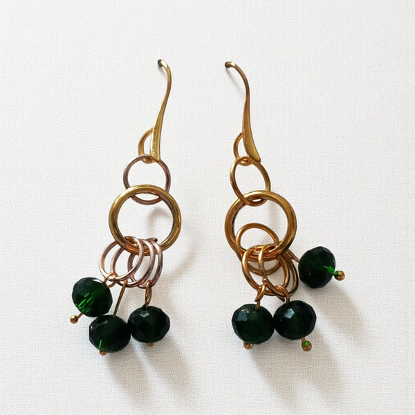 Gold toned earrings with black beads