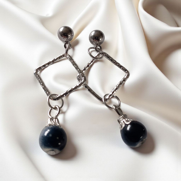 Silver tone earrings with blue glass stone