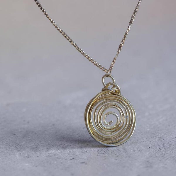 Hammered spiral pendant in gold