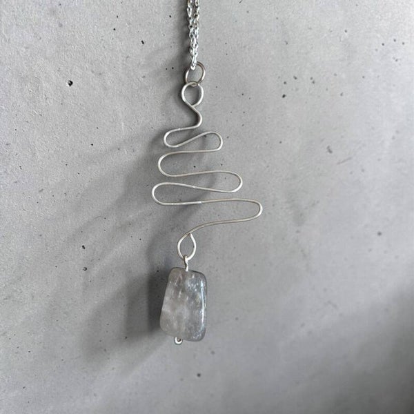 Quirky silver toned pendant