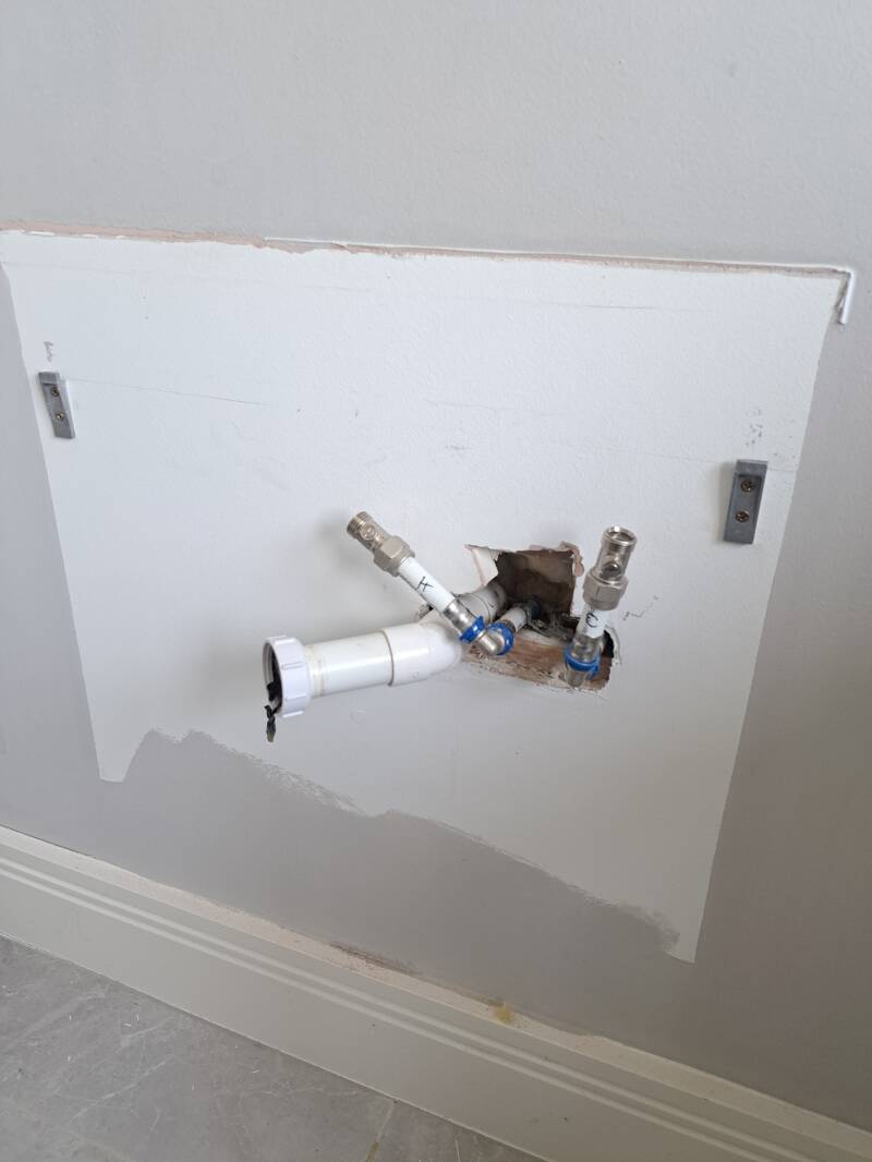 Exposing leaking pipework behind vanity unit.  Foxrock Leak Detection 