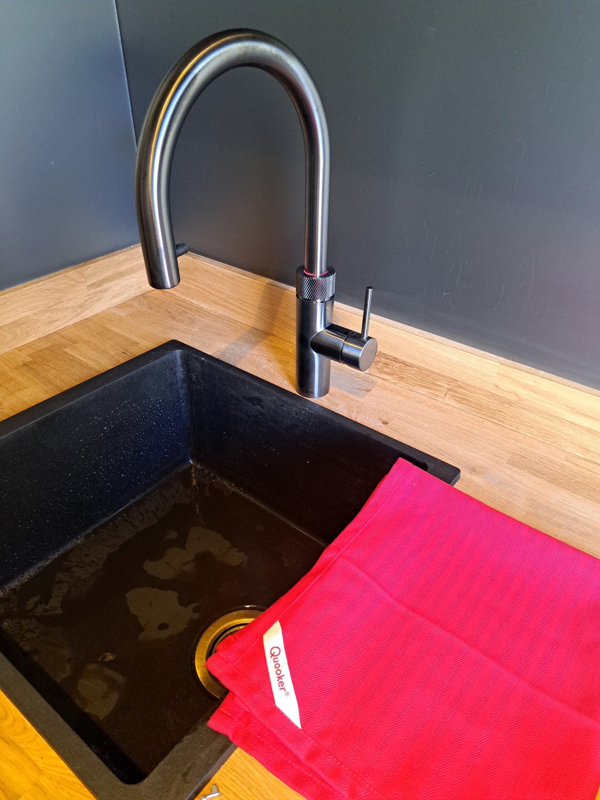 Quooker tap installed by LeakSOS. LeakSOS uniform in background 