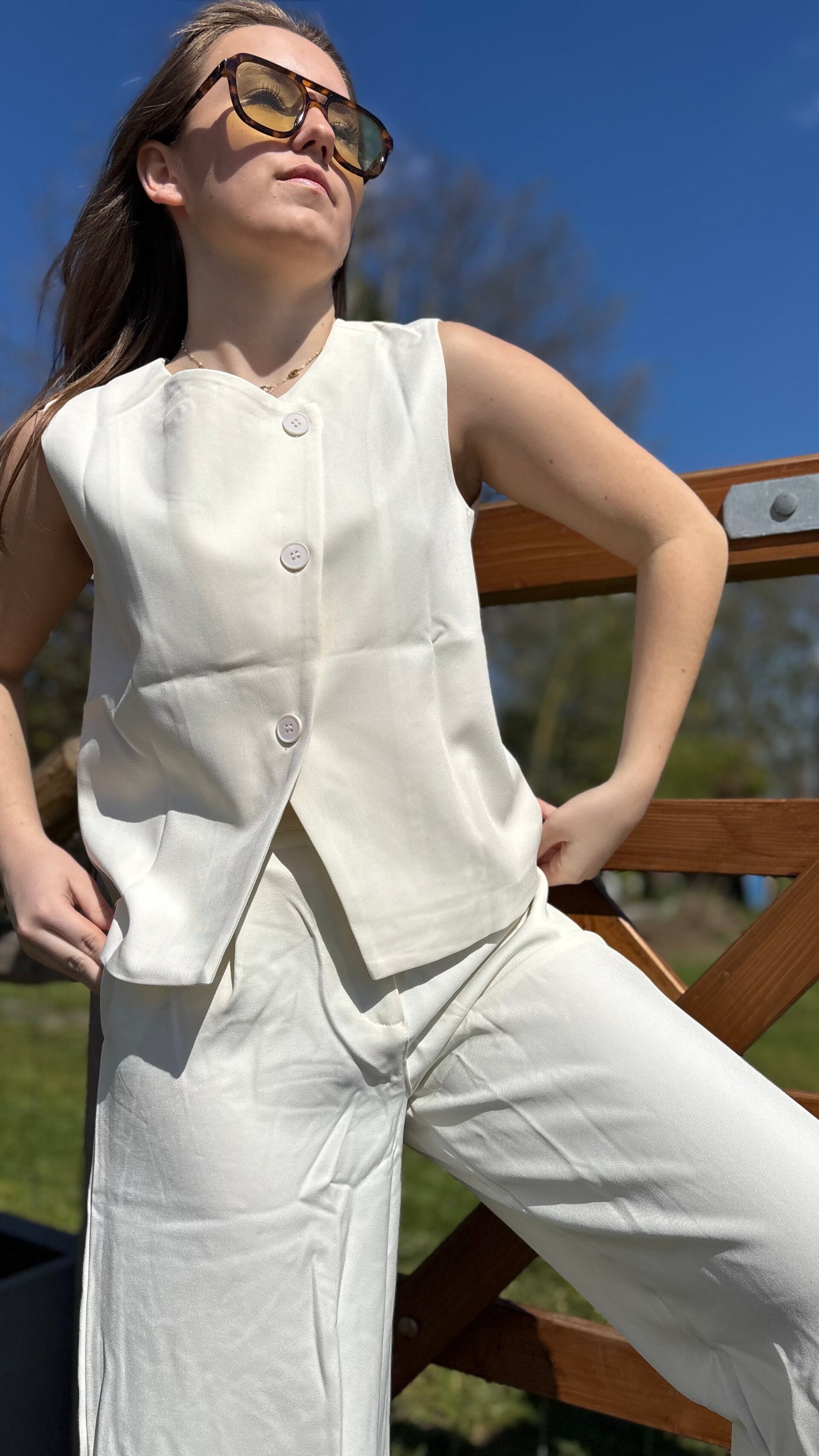 Sleeveless top with asymmetric buttons