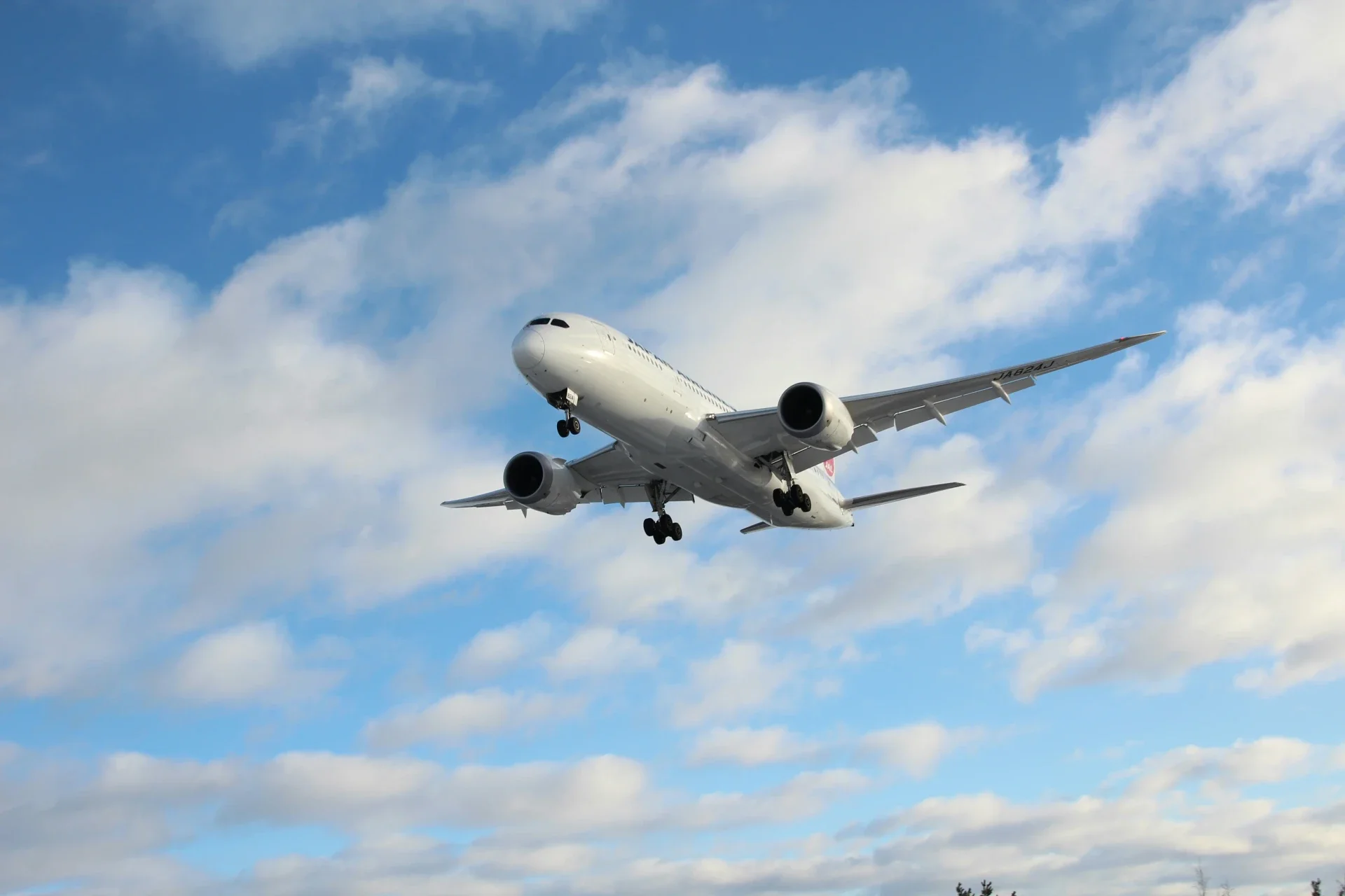airplane flying through a blue sky