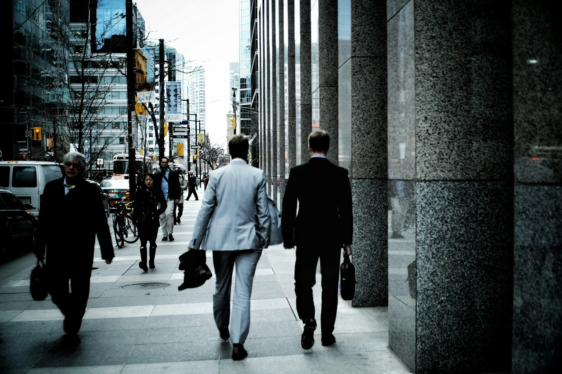 Business professionals walking along a city sidewalk