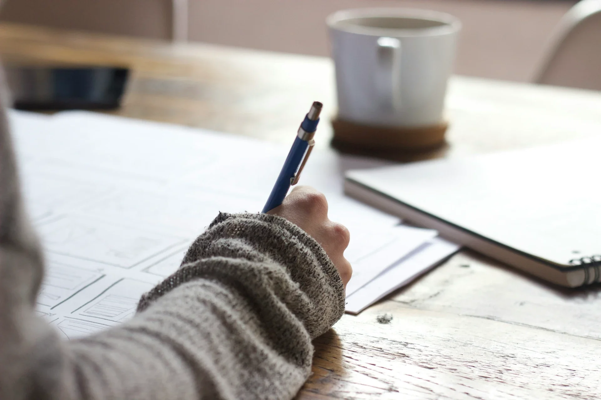 Close-up writing notebook at desk