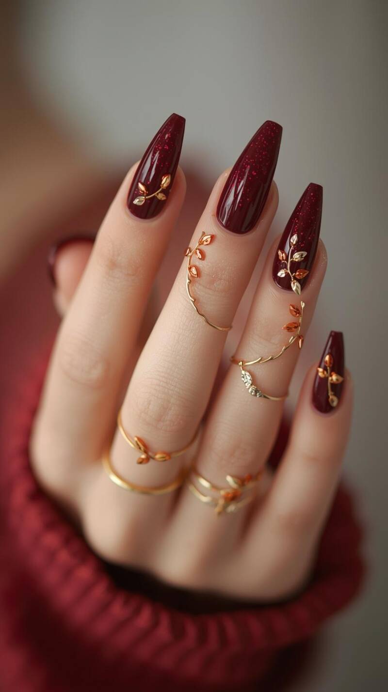 _a-close-up-of-a-female-hand-with-coffin-nails-painted-in-deep-burgundy-accent-nails-feature-cascading-tiny-golden-and-orange-leaves-as-if-falling-down-the-nail-t-2-standard.jpg