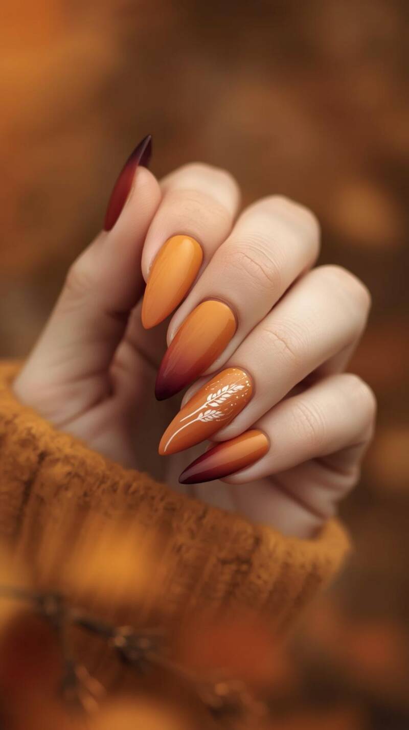 _a-female-hand-with-coffin-shaped-nails-featuring-a-gradient-ombre-of-mustard-yellow-burnt-orange-and-deep-maroon-one-accent-nail-has-a-subtle-wheat-stalk-design-3-standard.jpg