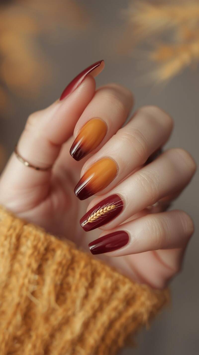 _a-female-hand-with-coffin-shaped-nails-featuring-a-gradient-ombre-of-mustard-yellow-burnt-orange-and-deep-maroon-one-accent-nail-has-a-subtle-wheat-stalk-design-rep-standard-alp3qf.jpg