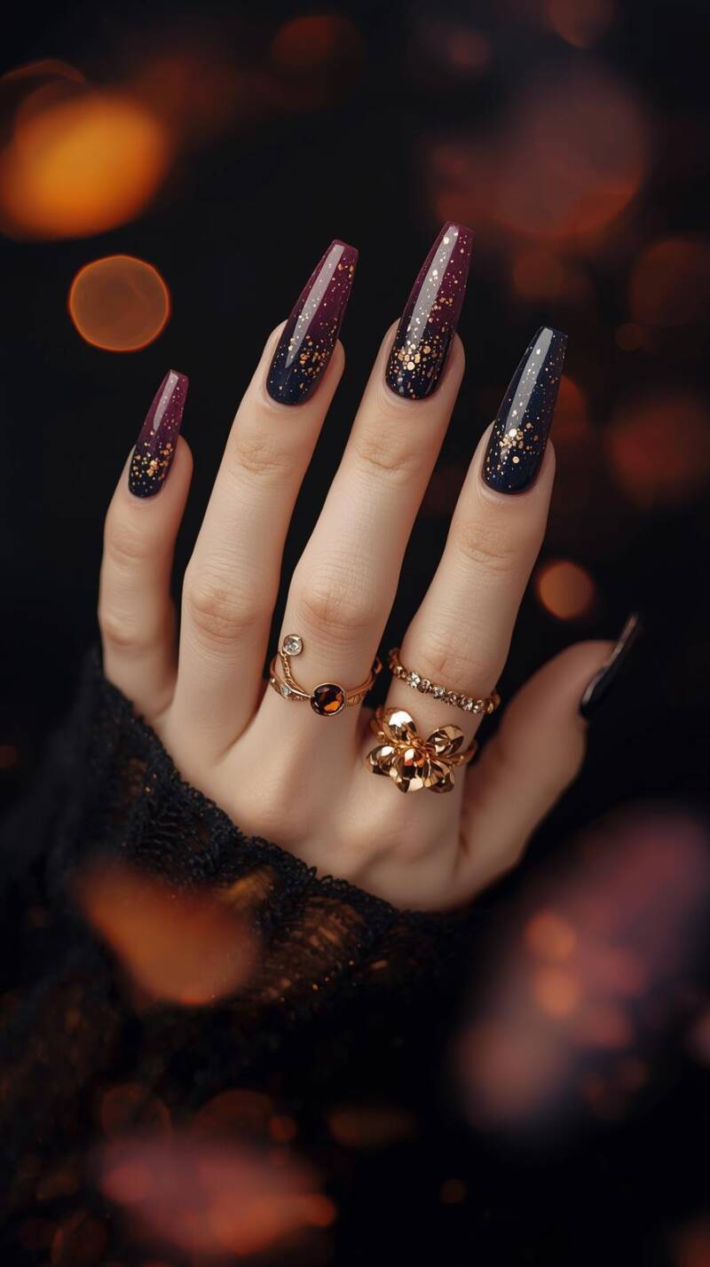 _a-female-hand-with-long-stiletto-nails-painted-in-a-gradient-of-plum-purple-to-midnight-navy-gold-flecks-shimmer-across-accent-nails-resembling-a-fall-night-sky-1-standard.jpg