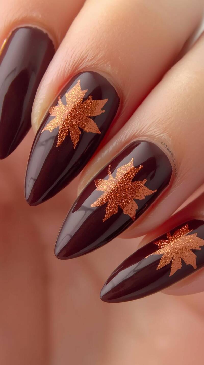_a-realistic-shot-of-long-almond-nails-painted-in-glossy-chocolate-brown-accent-nails-shimmer-with-copper-glitter-and-feature-delicate-maple-leaf-outlines-in-warm-o-1-standard.jpg
