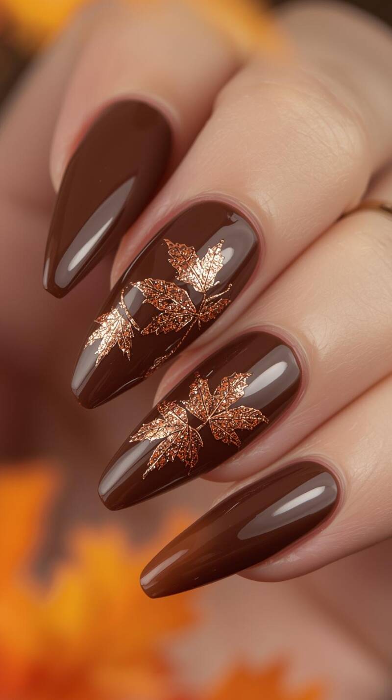 _a-realistic-shot-of-long-almond-nails-painted-in-glossy-chocolate-brown-accent-nails-shimmer-with-copper-glitter-and-feature-delicate-maple-leaf-outlines-in-warm-orang-standard.jpg
