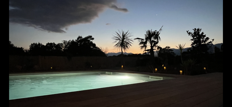 Coucher de soleil avec piscine éclairée de la villa