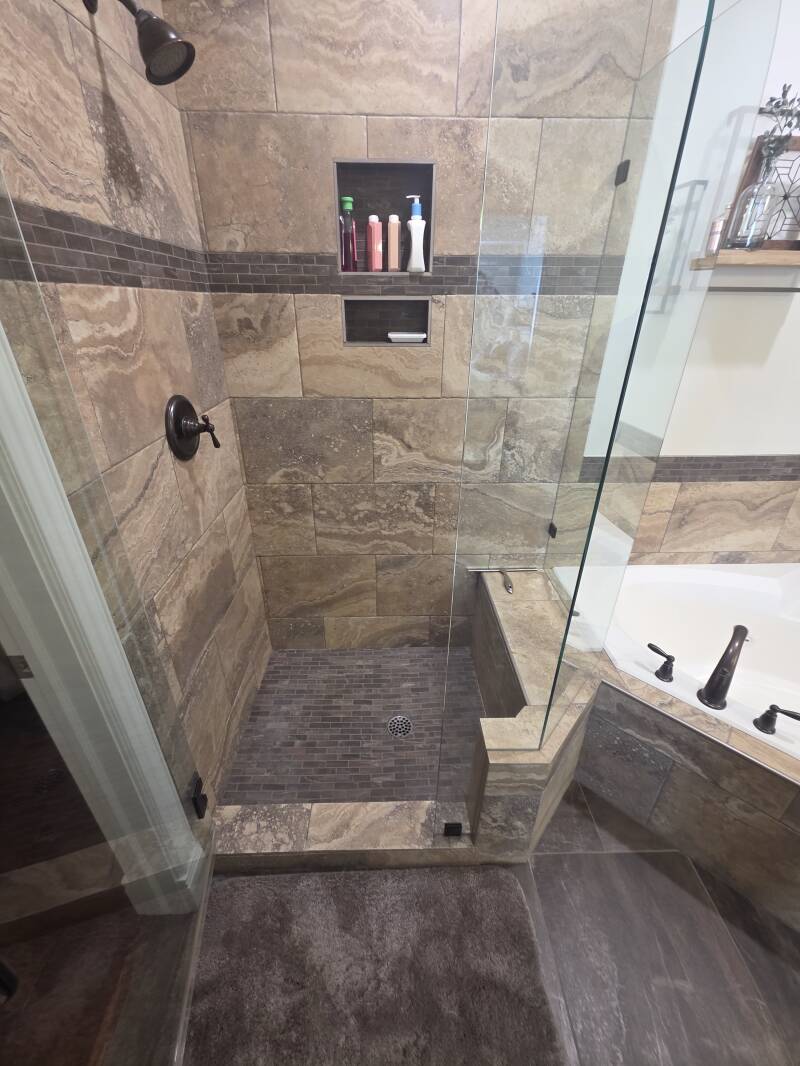 ADA‑Friendly Shower Upgrade — South Jordan, Utah Professional shower renovation featuring dual grab bars, handheld showerhead for improved safety and accessibility.