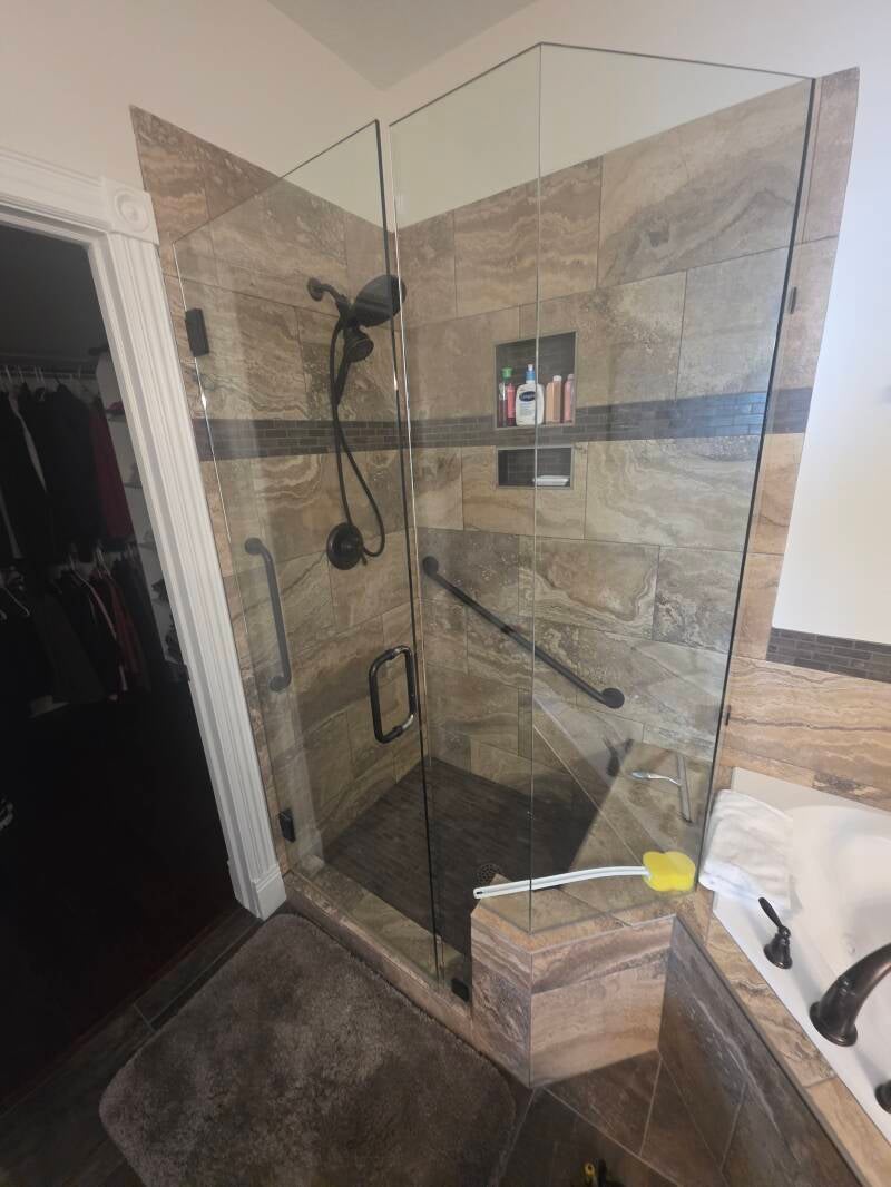 ADA‑Friendly Shower Upgrade — South Jordan, Utah Professional shower renovation featuring dual grab bars, handheld showerhead for improved safety and accessibility.