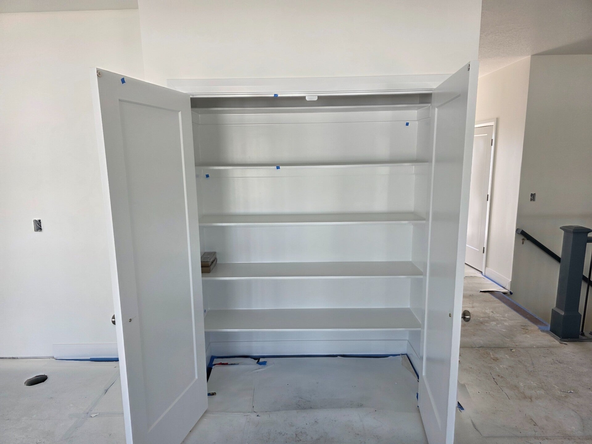 White closet shelving and double doors during finish work in Kaysville