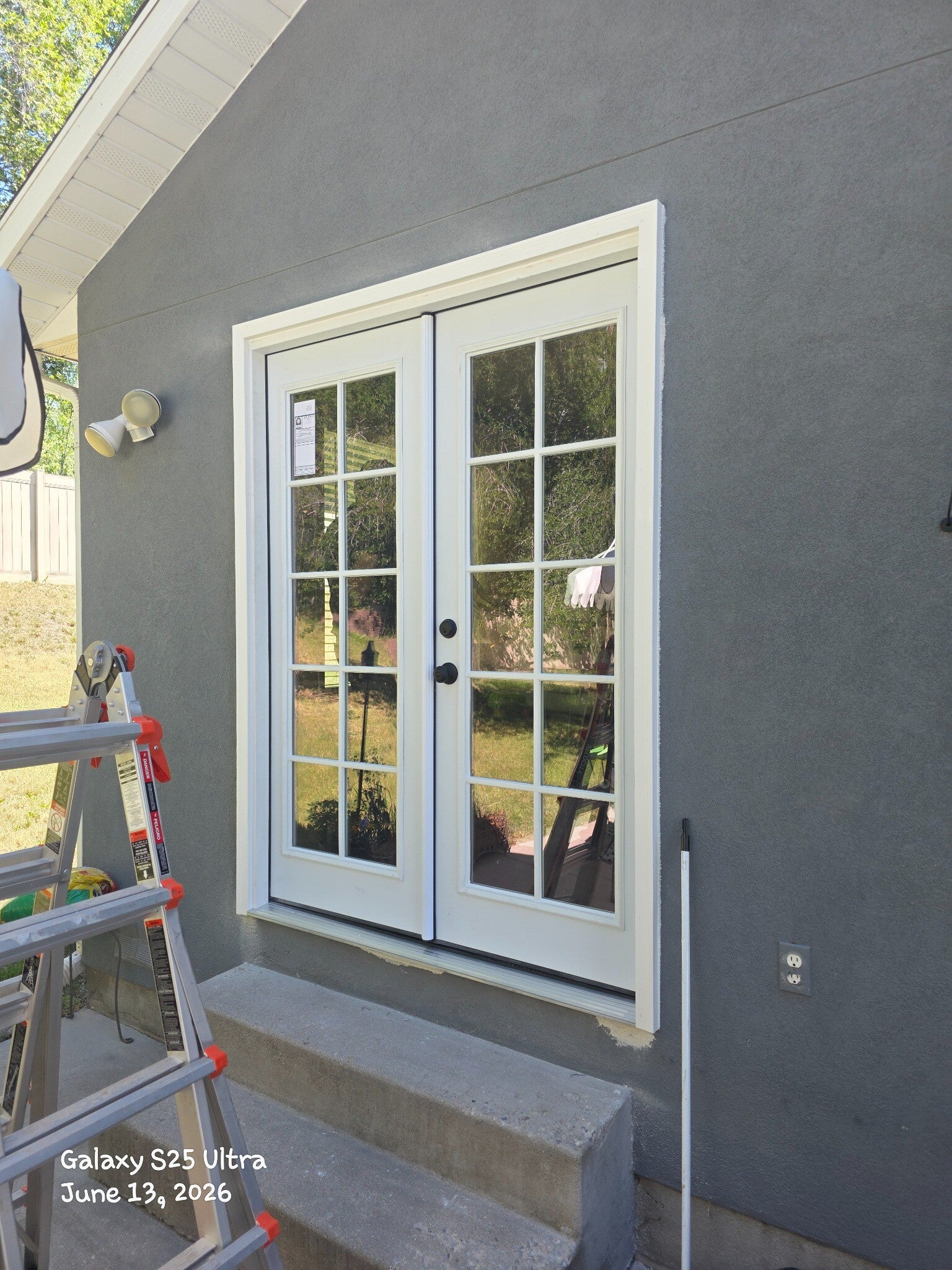White exterior French doors during installation at a Kaysville home