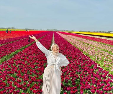 Woman standing in a field of flowers