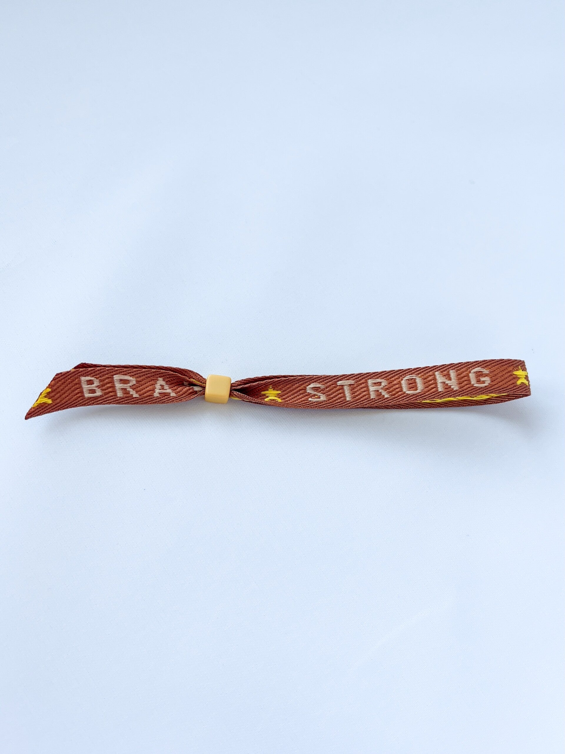 Kinderarmband lint met tekst 'Strong Brave' - oranje geel