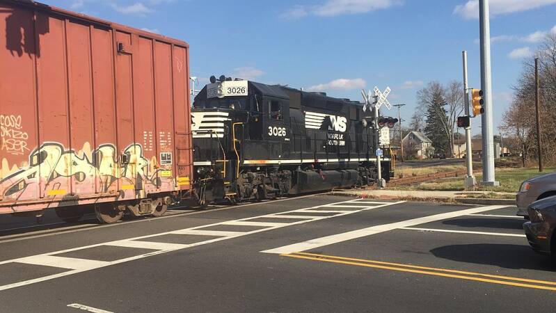  A Norfolk Southern GP40-2 3026 (ex Conrail Blue)  pulls a short freight train across Ark Road in Mount Laurel, New Jersey.